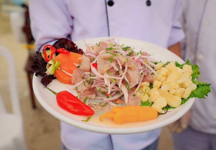 Plate of Peruvian ceviche with sweet potato and corn