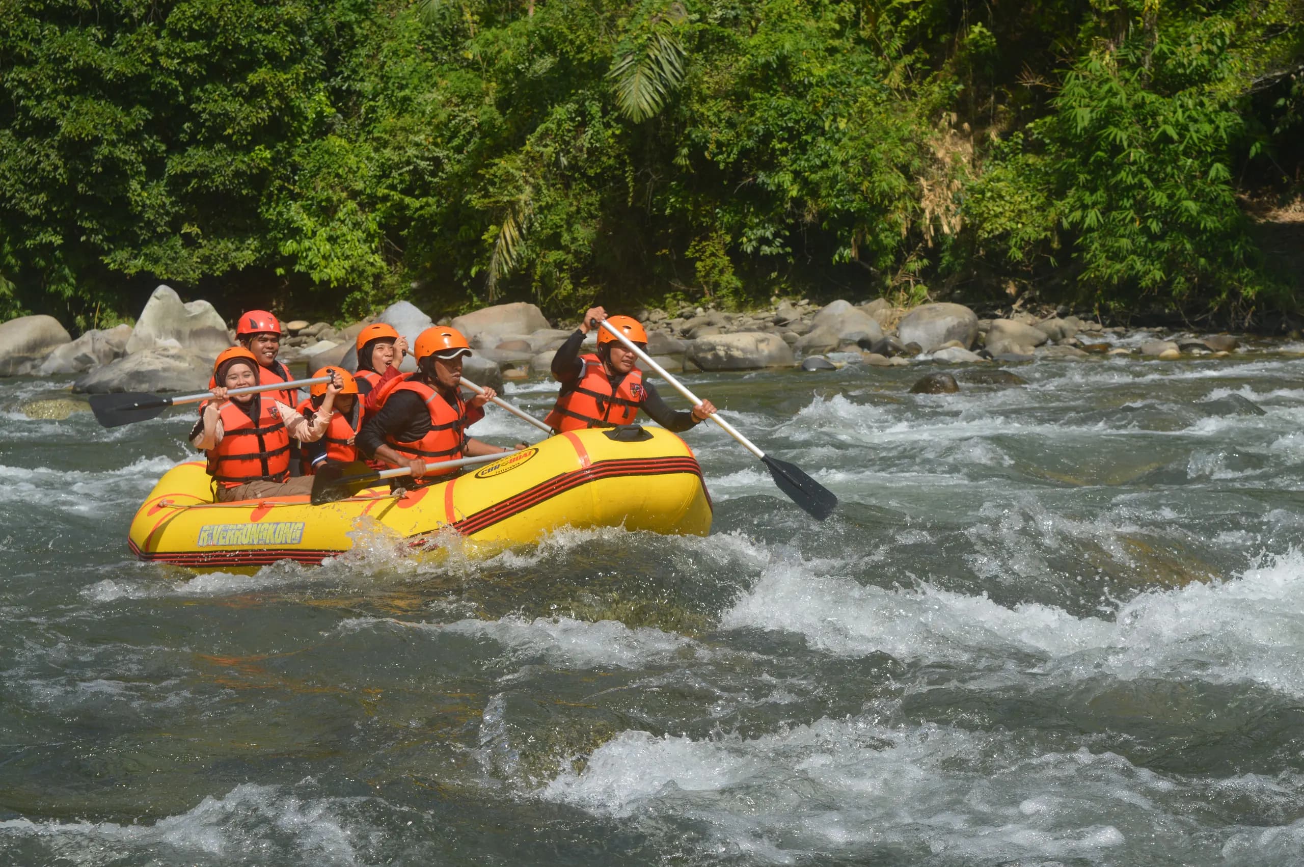 Travellers rafting through river rapids