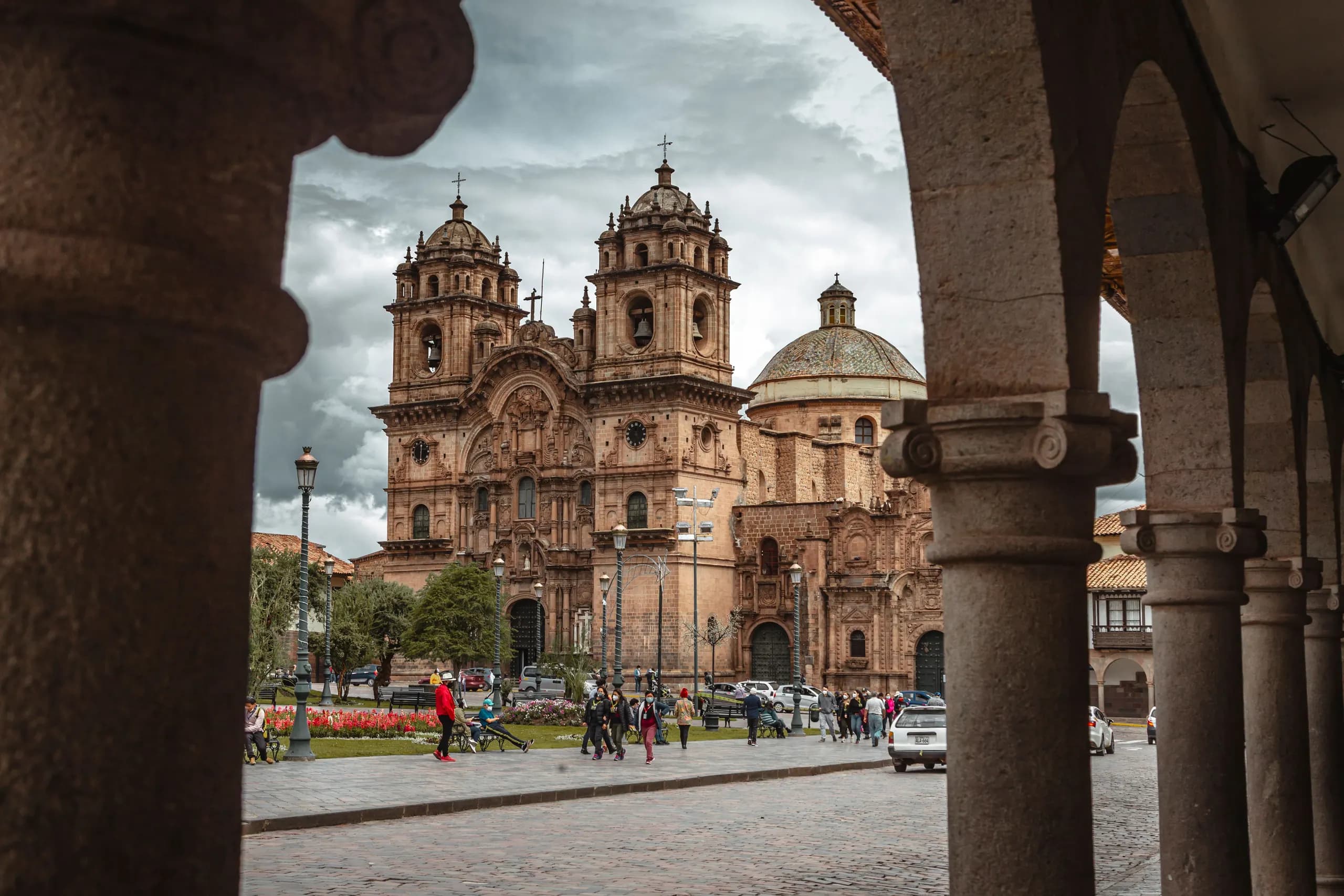Cusco Cathedral seen through a stone arch at the Plaza de Armas