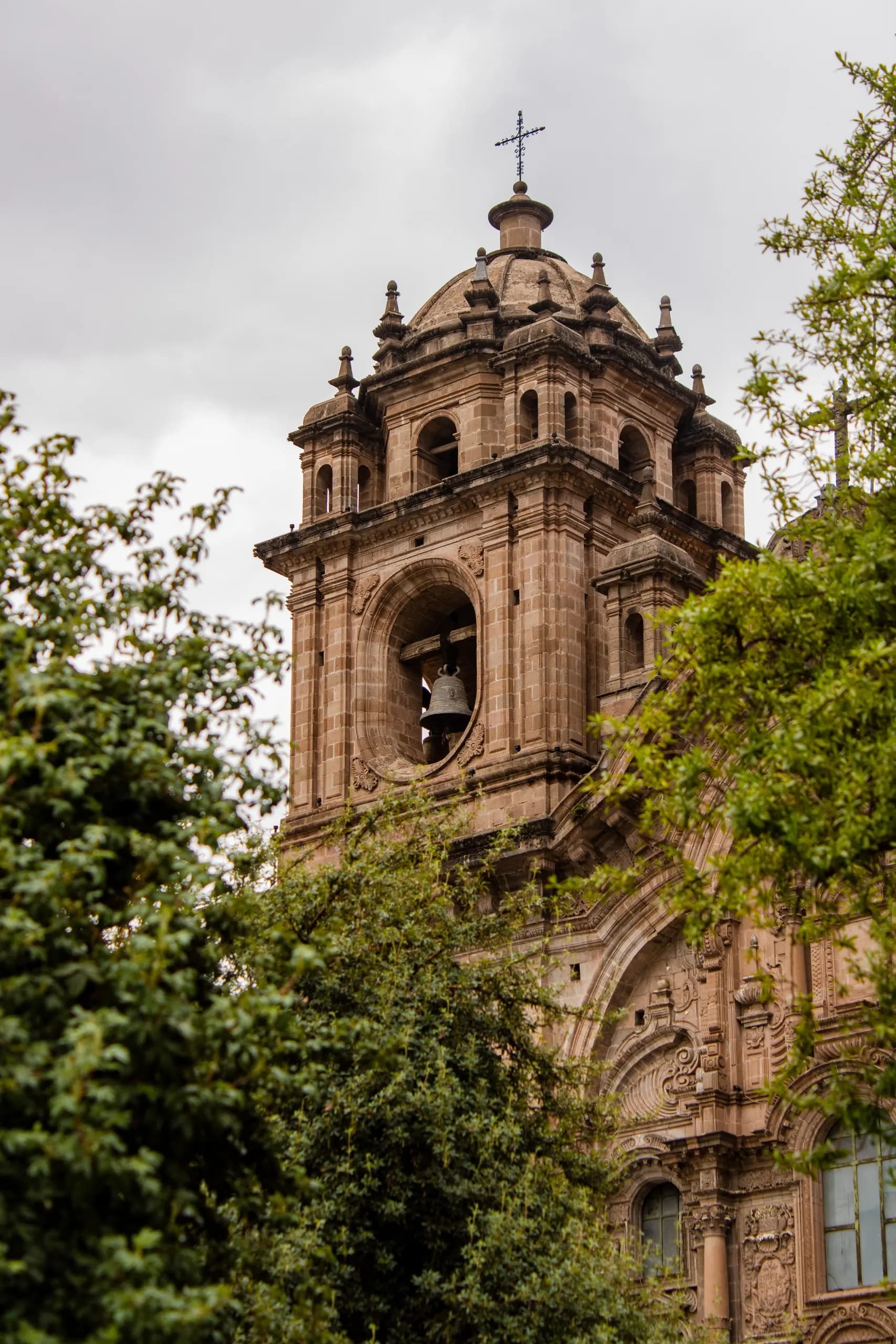 Church tower among the trees in Cusco