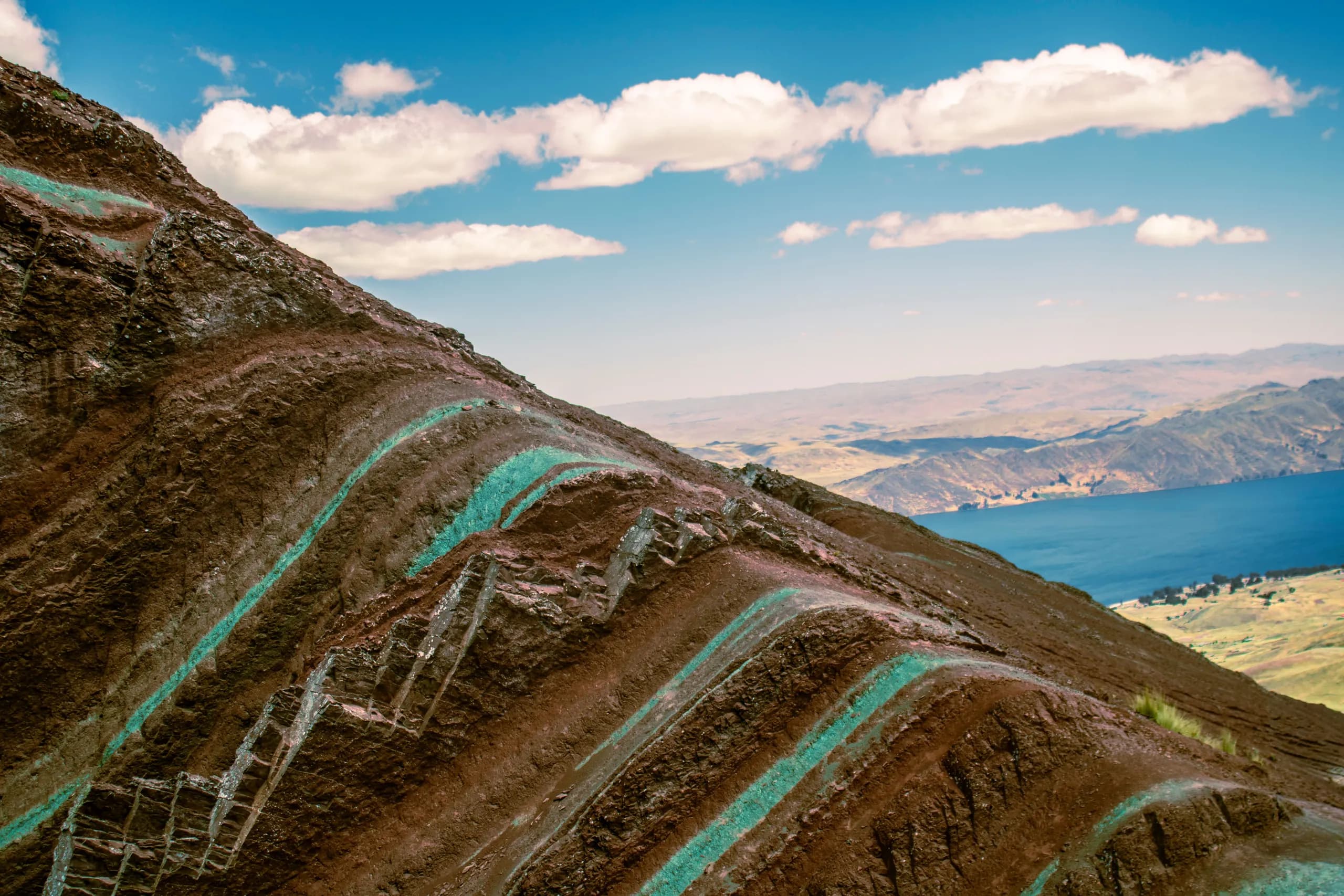 Colourful slopes beside an Andean lake