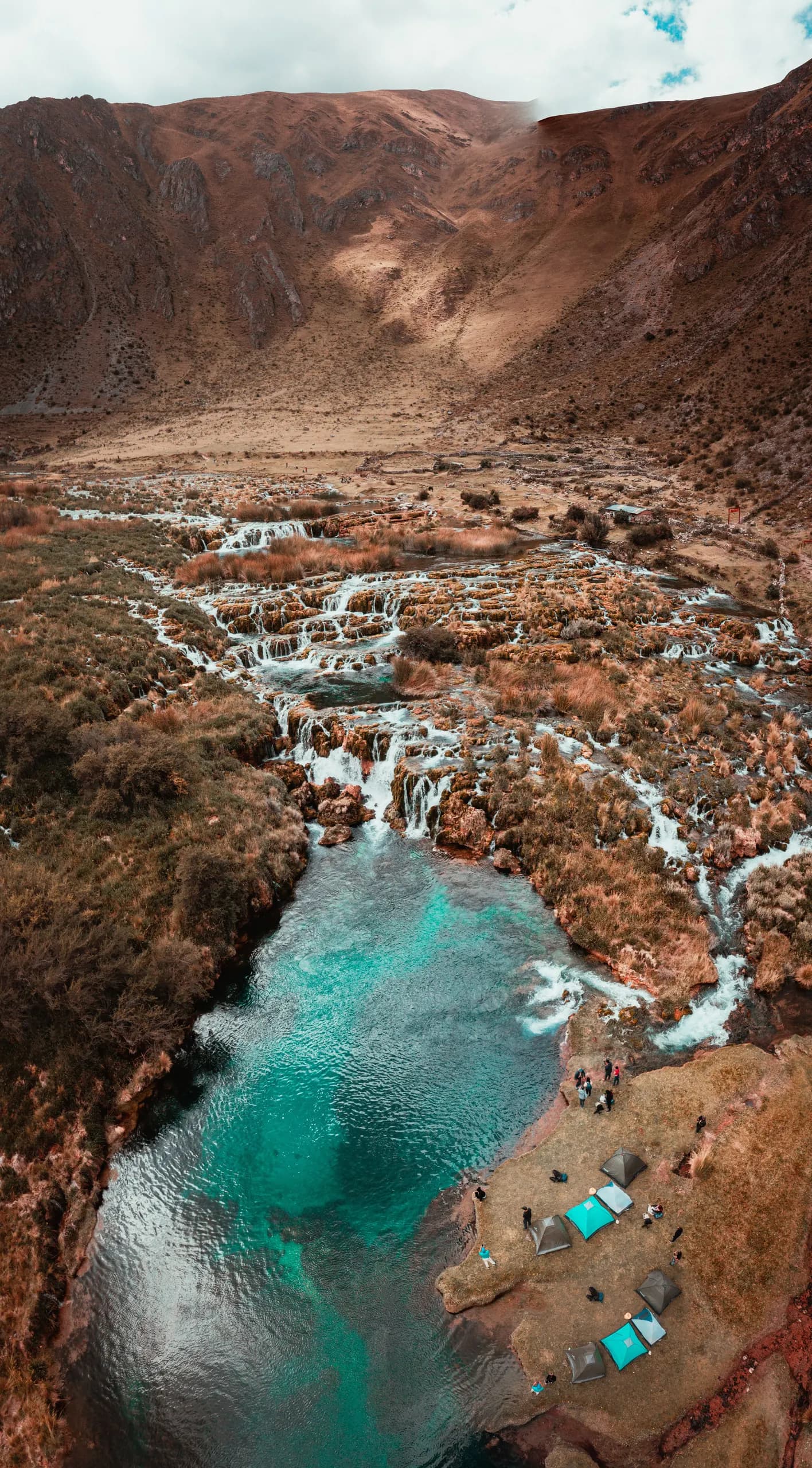 Elevated view of the waterfalls and turquoise pools of Huancaya