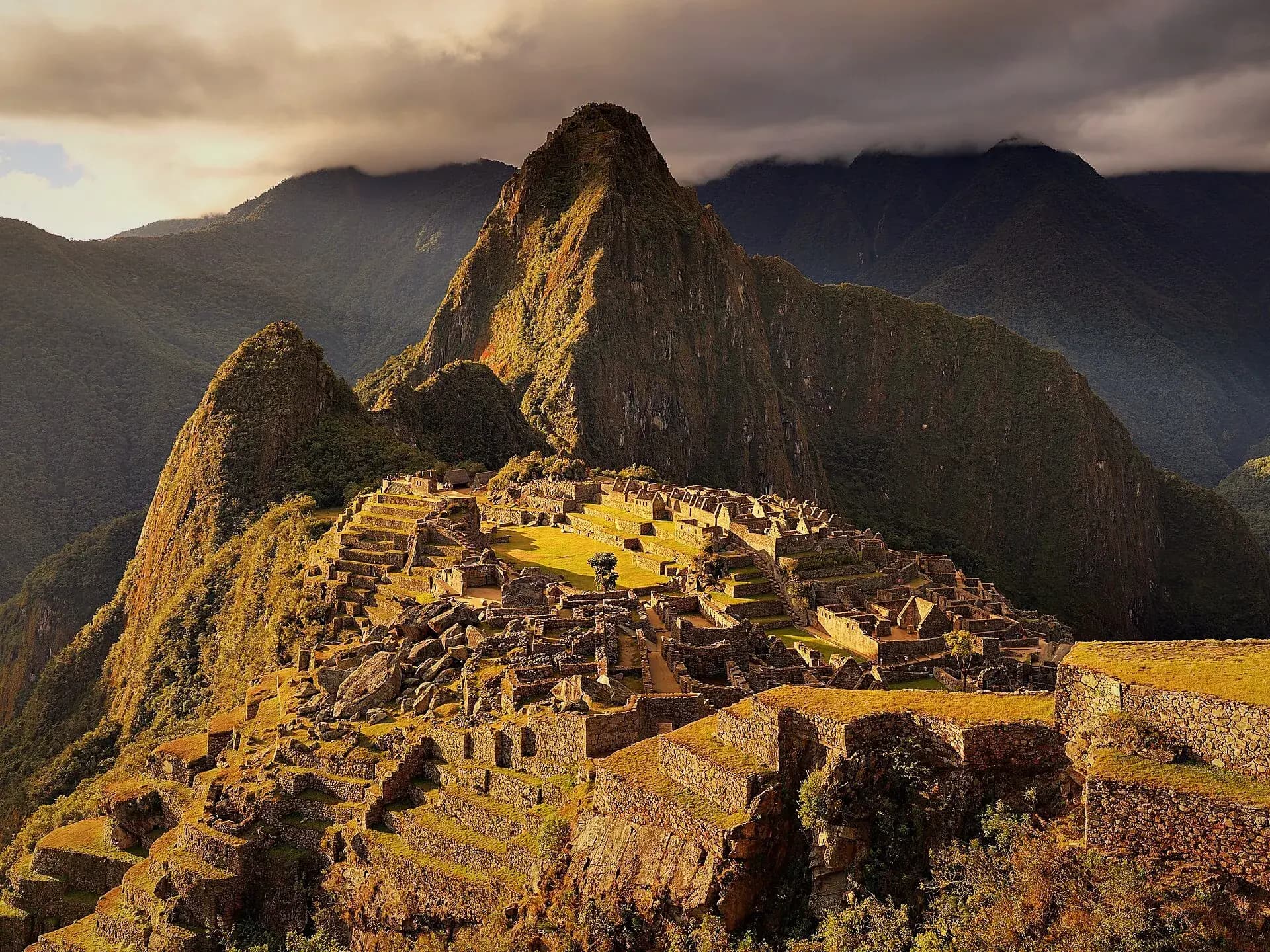 Machu Picchu lit by golden light among the mountains