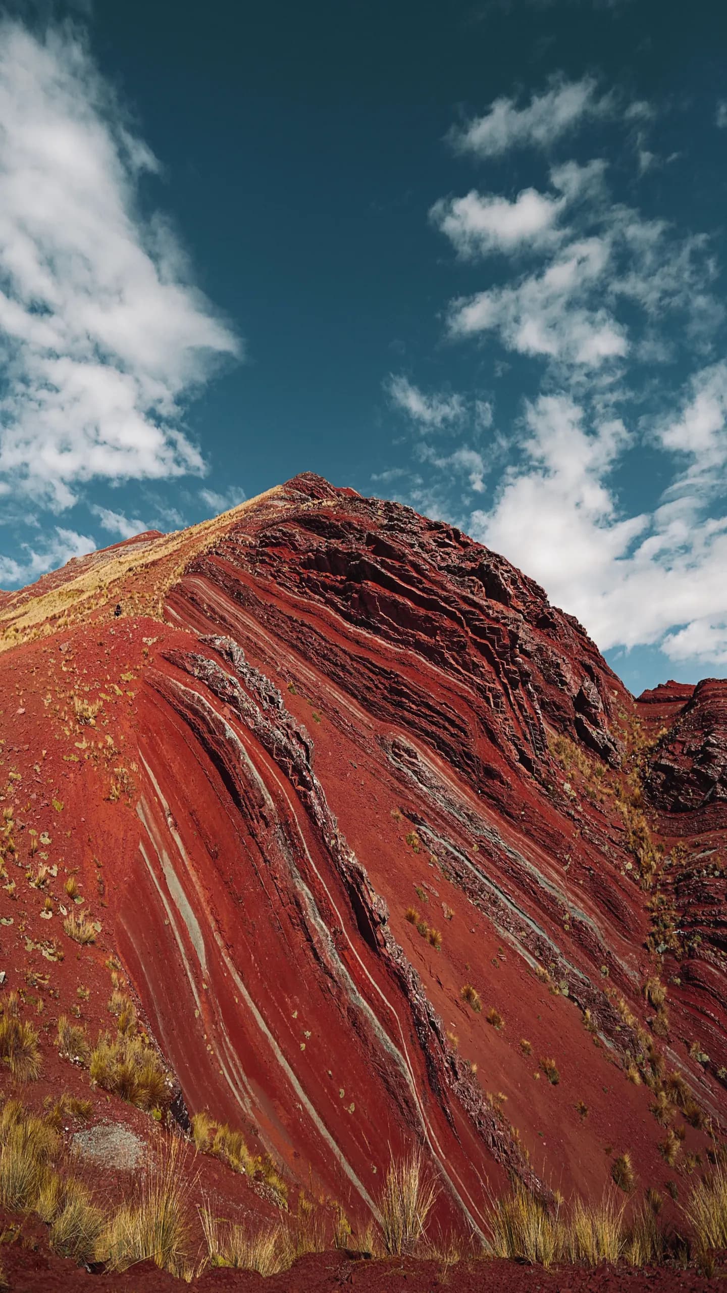 Colourful mountain slopes beneath a blue sky