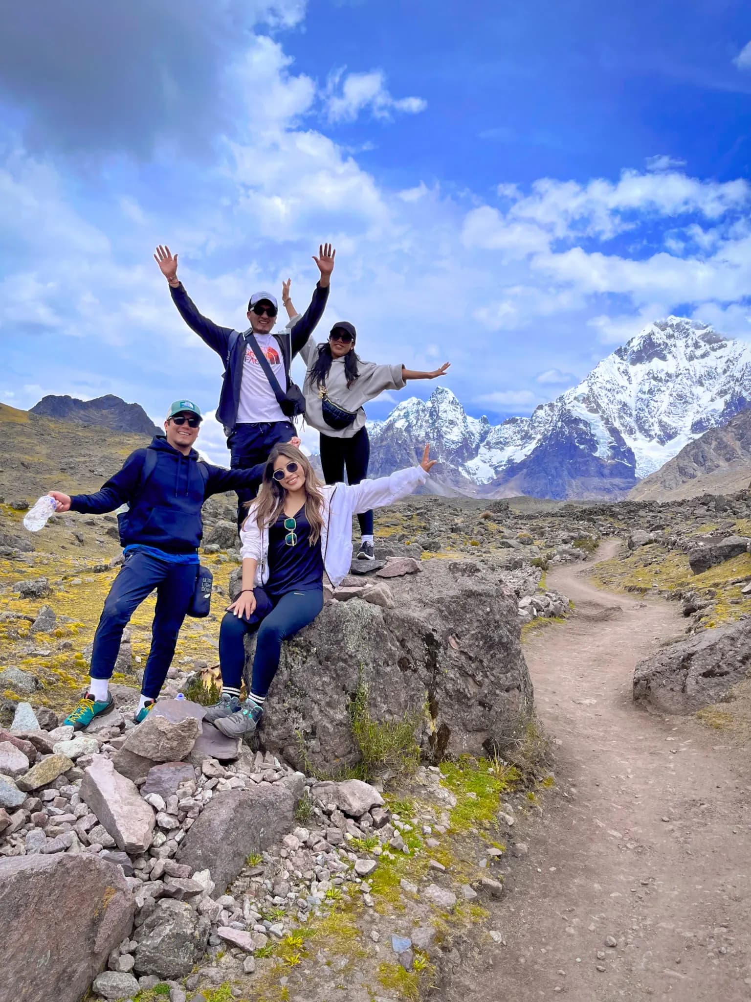 Group of hikers on the Salkantay Trek below snow-capped peaks