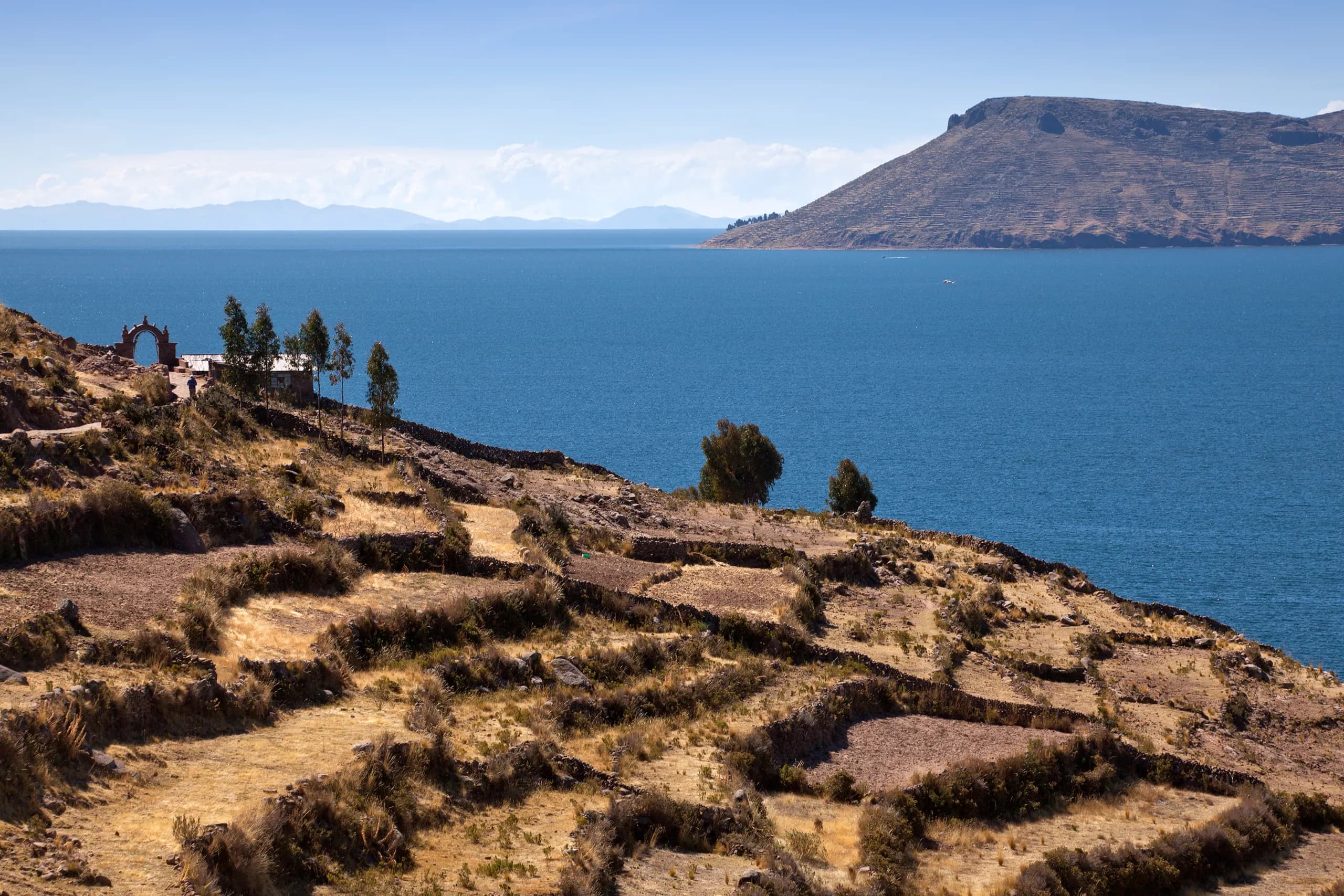Landscape of Taquile Island beside the blue waters of Lake Titicaca