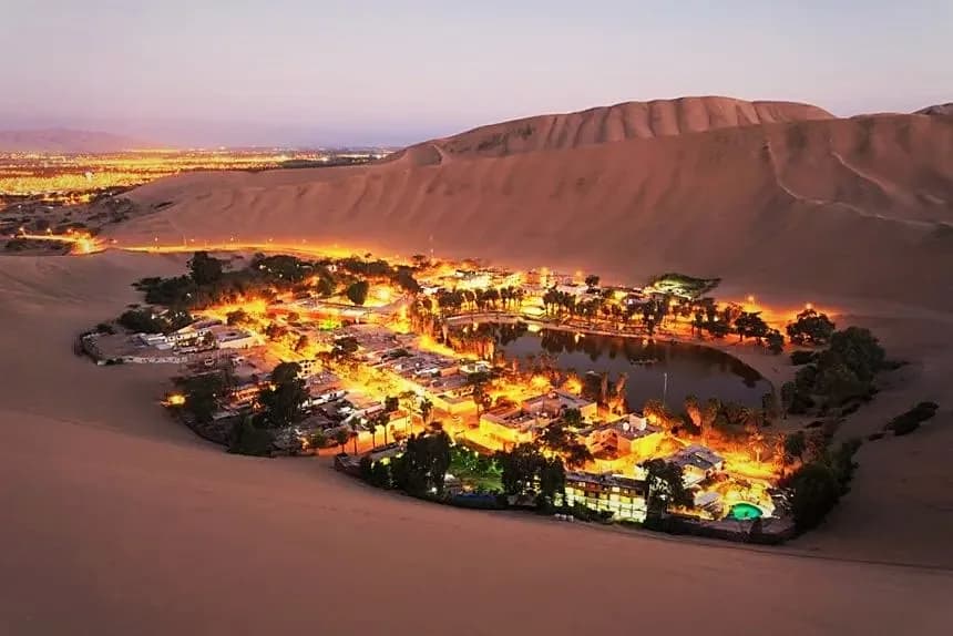 Huacachina oasis among the sand dunes at dusk, Ica