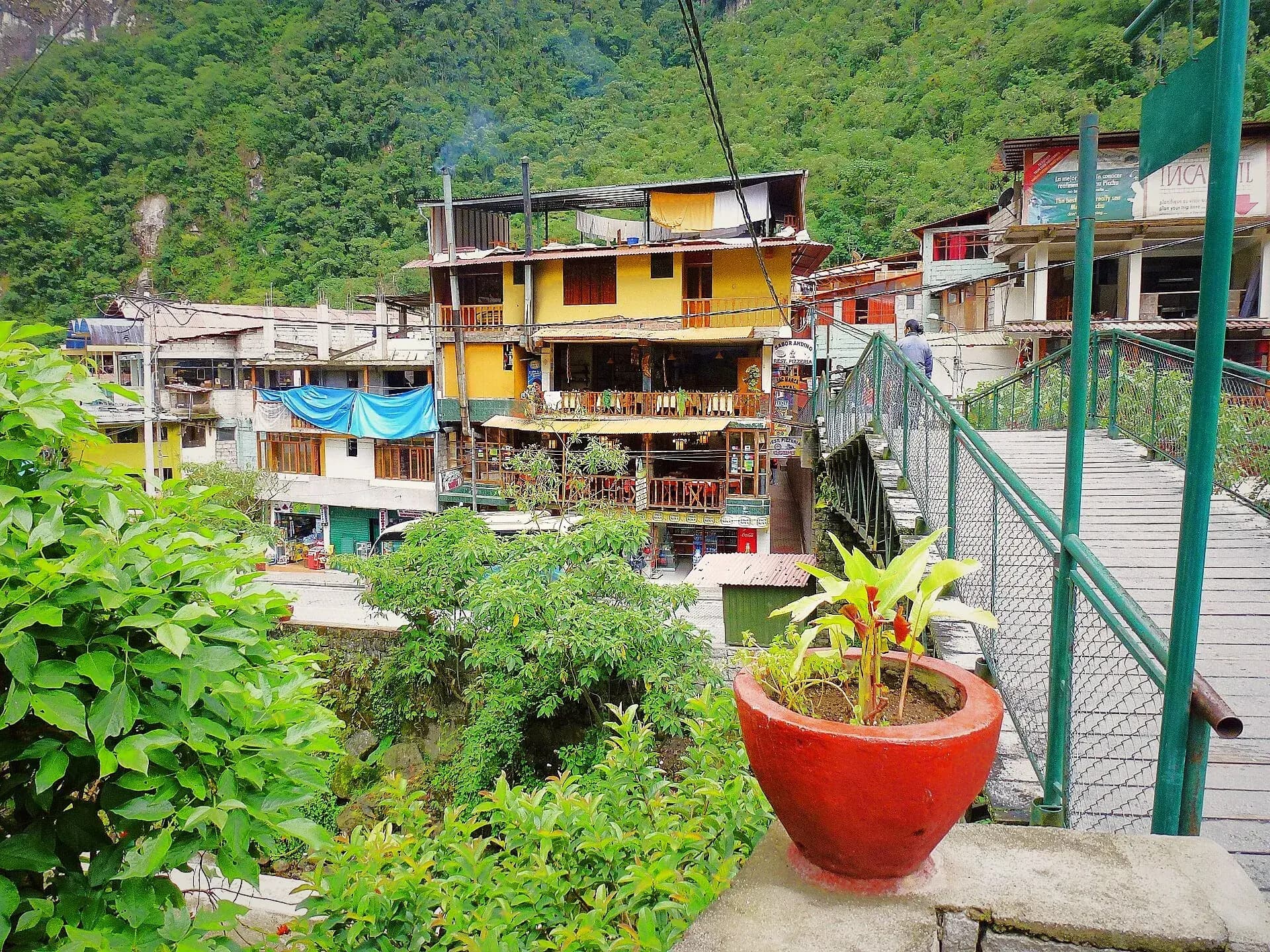 Street in Aguas Calientes among buildings and mountain vegetation