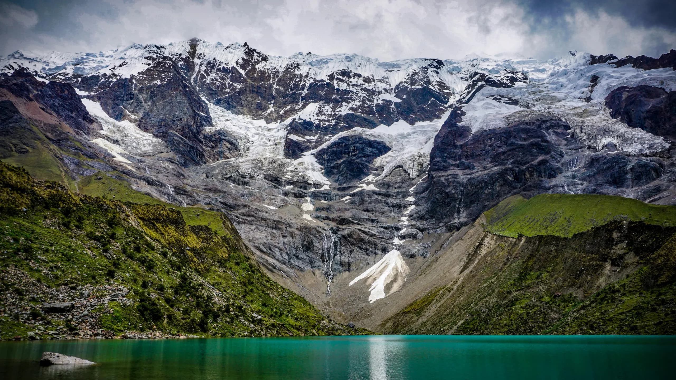 © Giacomo Buzzao · Unsplash Turquoise waters of Humantay Lake below a glacier, between rocky slopes
