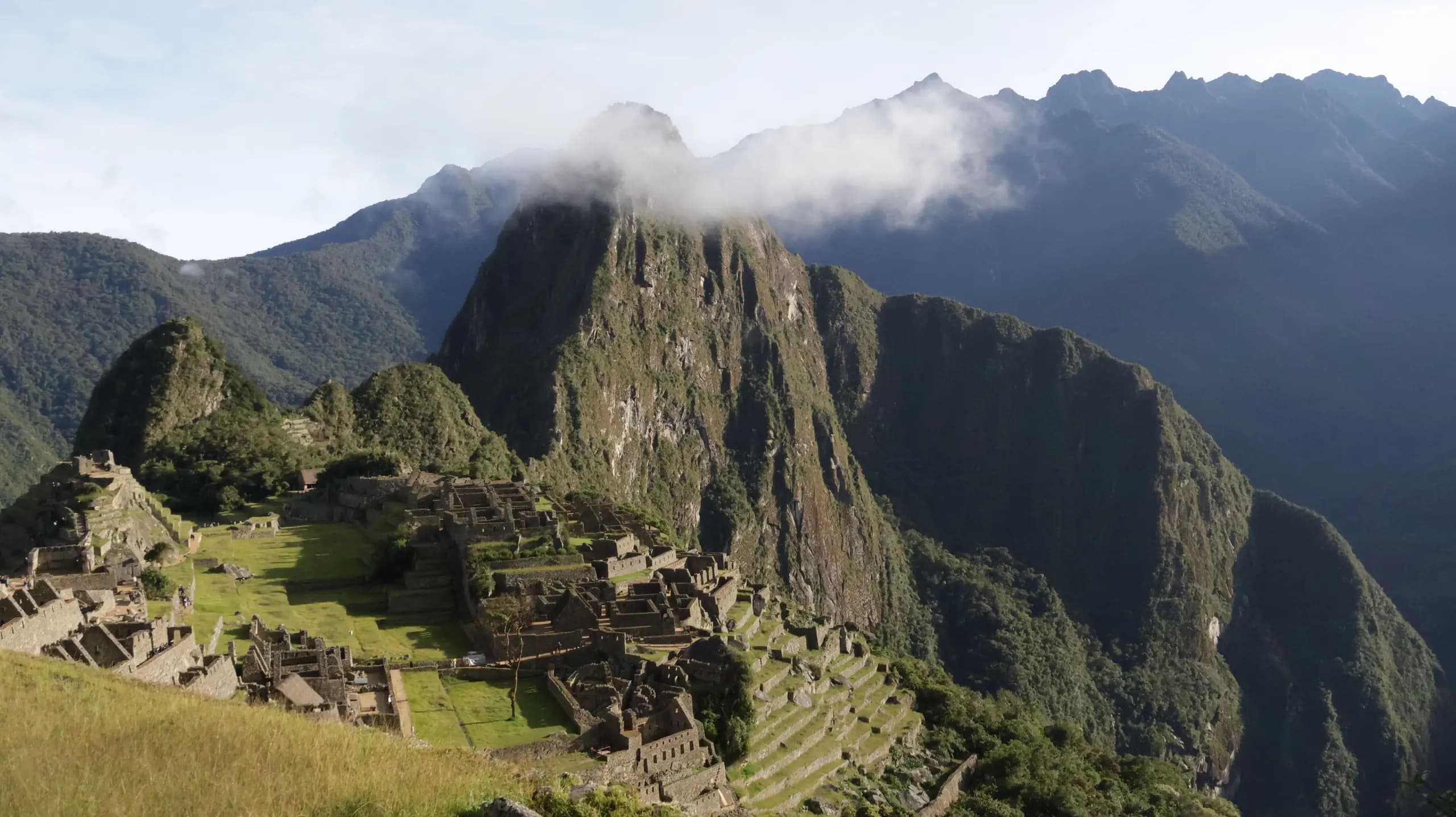 © natalia mora · Pexels Machu Picchu surrounded by mountains and clouds
