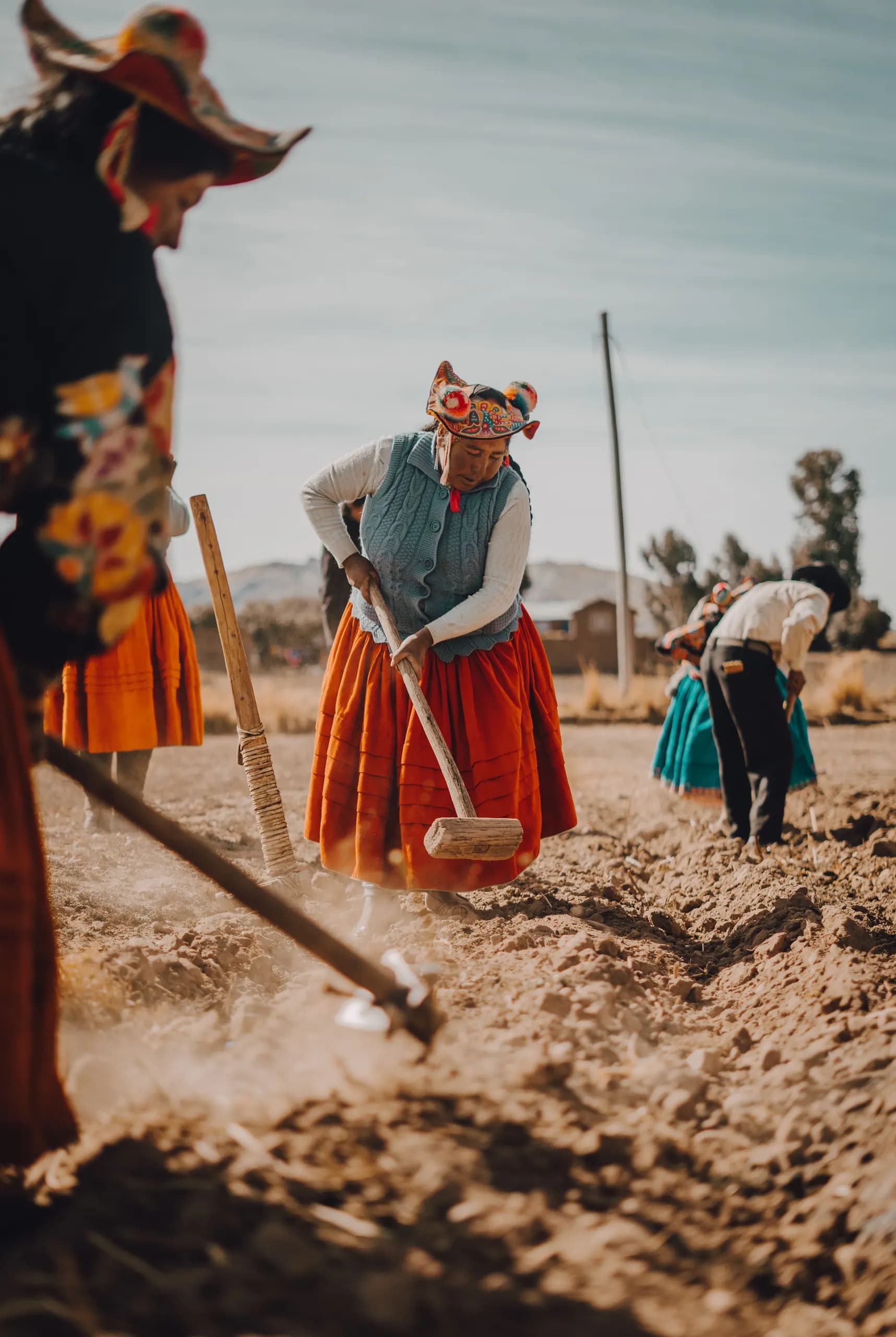 © sarai carrasco · Pexels Women in traditional Andean clothing work the soil with hand tools in a field in Cusco